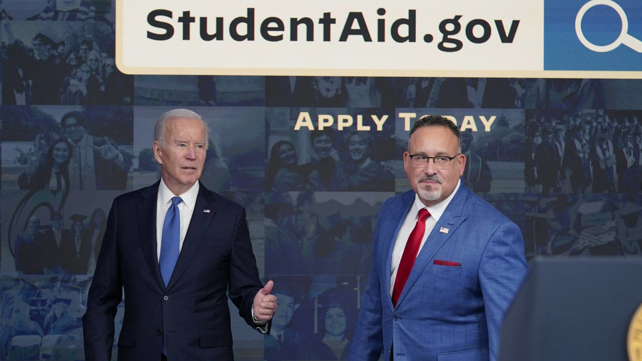 FILE - President Joe Biden answers questions with Education Secretary Miguel Cardona as they leave ...