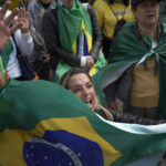 
              A supporter of Brazilian President Jair Bolsonaro holds a Brazilian flag during a protest against his reelection defeat, outside a military base in Sao Paulo, Brazil, Thursday, Nov. 3, 2022. Some supporters are calling on the military to keep Bolsonaro in power, even as his administration signaled a willingness to hand over the reins to his rival, President-elect Luiz Inacio Lula da Silva. (AP Photo/Matias Delacroix)
            