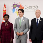 
              Tunisian President Kais Saied, right, and Louise Mushikiwabo, Secretary-General of the Organisation internationale de la Francophonie, left, receive Canadian Prime Minister Justin Trudeau during the opening ceremony of the 18th Francophone Summit, in Djerba, Tunisia, Saturday, Nov. 19, 2022. (AP Photo/Hassene Dridi)
            