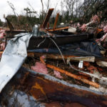 
              Police block off roads as cleanup begins on debris from a possible tornado that left two dead Wednesday, Nov. 30, 2022, in Flatwood, Ala. (AP Photo/Butch Dill)
            
