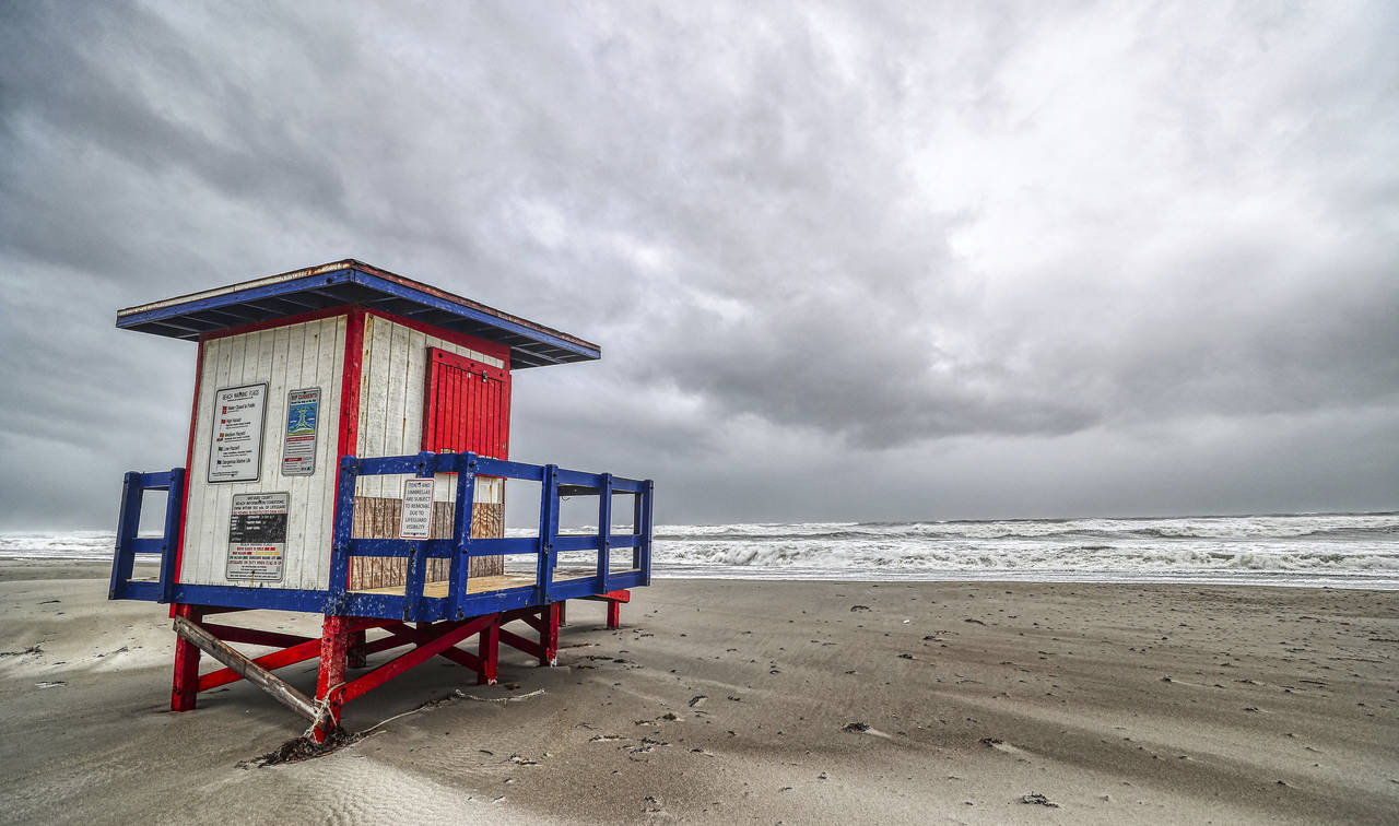 A lifeguard hut looks out to the ocean as Tropical Storm Nicole makes its presence felt Wednesday, ...