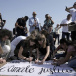 
              Climate activists work on a sign that reads "don't be scared of climate justice" at the designated protest zone for the COP27 U.N. Climate Summit, Tuesday, Nov. 15, 2022, in Sharm el-Sheikh, Egypt. (AP Photo/Nariman El-Mofty)
            
