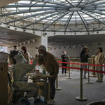 
              People wearing face masks stand in line for their routine COVID-19 tests at a coronavirus testing site setup at a tunnel in the central business district of Beijing, Wednesday, Nov. 16, 2022. Chinese authorities locked down a major university in Beijing on Wednesday after finding one COVID-19 case as they stick to a "zero-COVID" approach despite growing public discontent. (AP Photo/Andy Wong)
            