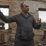 
              Vadym Zherdetsky talks to The Associated Press amid the wreckage of his house destroyed by fighting, in the village of Moshun, outside Kyiv, Ukraine, Friday, Nov. 4, 2022. (AP Photo/Andrew Kravchenko)
            