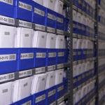 
              Stacks of collectibles fill shelves housed in a safe at Collectors Vault on Oct. 21, 2022, in Delaware. Inside the boxes are sports cards, baseball bats, Pokemon cards and other pricey memorabilia. (AP Photo/Davidde Corran)
            