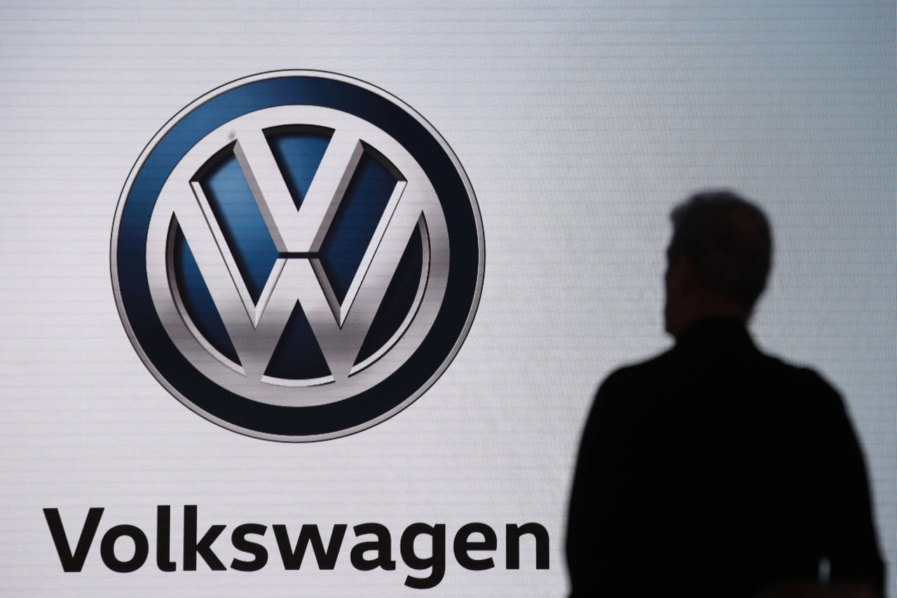 FILE - An attendee waits for the start of a news conference at the Volkswagen booth at the Los Ange...
