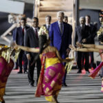 
              U.S. President Joe Biden, center, watches Balinese dancers perform upon his arrival to attend the G20 Summit at the Ngurah Rai International Airport in Bali, Indonesia, Sunday, Nov. 13, 2022. (Made Nagi/Pool Photo via AP)
            