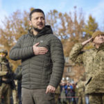 
              In this photo provided by the Ukrainian Presidential Press Office, Ukrainian President Volodymyr Zelenskyy listens to the national anthem during his visit to Kherson, Ukraine, Monday, Nov. 14, 2022. Ukraine's retaking of Kherson was a significant setback for the Kremlin and it came some six weeks after Russian President Vladimir Putin annexed the Kherson region and three other provinces in southern and eastern Ukraine — in breach of international law — and declared them Russian territory. (Ukrainian Presidential Press Office via AP)
            