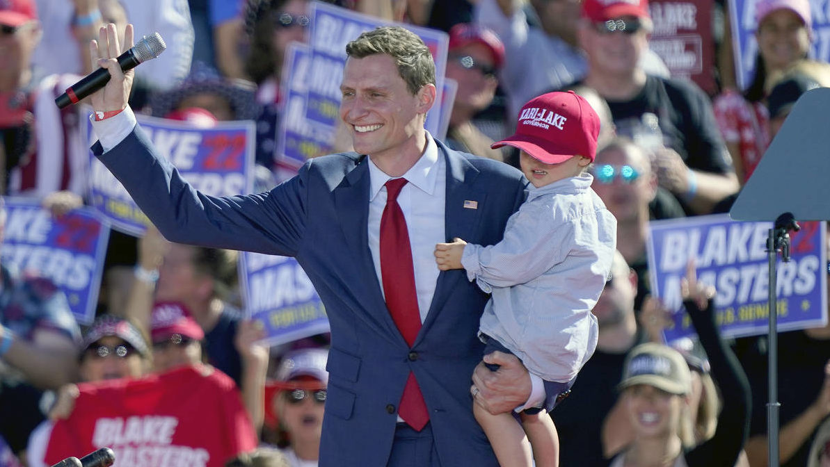FILE - Republican U.S. Sen. candidate Blake Masters holds his son Rex, 2, as he speaks at a rally, ...