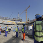 
              FILE - Workers work at Lusail Stadium, one of the 2022 World Cup stadiums, in Lusail, Qatar, Friday, Dec. 20, 2019.  (AP Photo/Hassan Ammar, File)
            