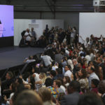 
              People watch Brazilian President-elect Luiz Inacio Lula da Silva on screen from a packed overflow room as he speaks at the COP27 U.N. Climate Summit, Wednesday, Nov. 16, 2022, in Sharm el-Sheikh, Egypt. (AP Photo/Thomas Hartwell)
            