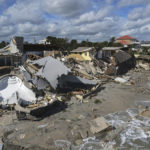 
              Homes are damaged and collapsed after the shore on which they stood was swept away, following the passage of Hurricane Nicole, Friday, Nov. 11, 2022, in Wilbur-By-The-Sea, Fla. (AP Photo/Rebecca Blackwell)
            