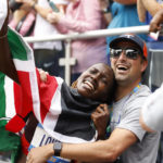 
              Sharon Lokedi, of Kenya, reacts with her coach Stephen Haas after crossing the finish line first in the women's division division of the New York City Marathon, Sunday, Nov. 6, 2022, in New York. (AP Photo/Jason DeCrow)
            