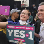 
              FILE - California Gov. Gavin Newsom, right, takes selfies with supporters at a turn out and vote YES on Proposition 1 rally at Long Beach City College in Long Beach, Calif., Nov. 6, 2022. Abortion rights supporters won in the four states where access was on the ballot Tuesday, as voters enshrined it into the state constitution in battleground Michigan as well as blue California and Vermont and dealt a defeat to an anti-abortion measure in deep-red Kentucky.  (AP Photo/Damian Dovarganes, File)
            