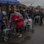 
              Residents queue to fill containers with drinking water in Kherson, southern Ukraine, Sunday, Nov. 20, 2022. Russian forces fired tank shells, rockets and other artillery on the city of Kherson, which was recently liberated from Ukrainian forces. (AP Photo/Bernat Armangue)
            