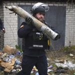 
              A Ukrainian sapper carries a part of a projectile during a demining operation in a residential area in Lyman, Donetsk region, Ukraine, Wednesday, Nov. 16, 2022. (AP Photo/Andriy Andriyenko)
            