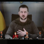 
              Ukrainian President Volodymyr Zelenskyy appears on a large screen as he speaks via video conference during the 68th Annual Session of the NATO Parliamentary Assembly in Madrid, Spain, Monday, Nov. 21, 2022. (AP Photo/Andrea Comas)
            