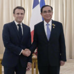 
              French President Emmanuel Macron, left, shakes hands with Thailand's Prime Minister Prayuth Chan-ocha at the Government House, Thursday, Nov. 17, 2022, in Bangkok, Thailand. (AP Photo/Sakchai Lalit, Pool)
            