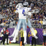 
              Dallas Cowboys running back Ezekiel Elliott celebrates with teammate quarterback Dak Prescott (4) after scoring on a 1-yard touchdown run during the second half of an NFL football game, Sunday, Nov. 20, 2022, in Minneapolis. (AP Photo/Bruce Kluckhohn)
            