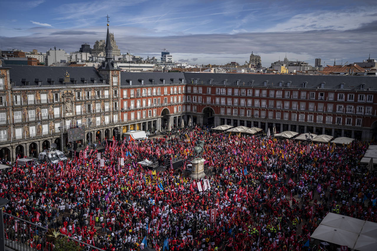 People gather during a protest to demand higher wages at the Mayor square in Madrid, Spain, Thursda...