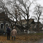 
              People stand near destroyed apartment buildings after Russian shelling in Pokrovsk, Donetsk region, Ukraine, Friday, Nov. 4, 2022. (AP Photo/Andriy Andriyenko)
            