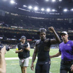
              Baltimore Ravens quarterback Lamar Jackson, center, celebrates after an NFL football game against the New Orleans Saints in New Orleans, Monday, Nov. 7, 2022. The Ravens won 27-13. (AP Photo/Butch Dill)
            