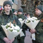 
              Two liberated soldiers hold bunches of flowers during a meeting after the exchange of servicemen of the Donetsk People's Republic and the Lugansk People's Republic who were imprisoned, in Amvrosiivka, Donetsk People's Republic, eastern Ukraine, Tuesday, Nov. 1, 2022. Russia and Ukraine on Saturday made an exchange of prisoners, which took place according to the formula "50 to 50". (AP Photo/Alexei Alexandrov)
            