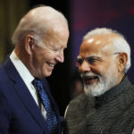 India's Prime Minister Narendra Modi talks with U.S. President Joe Biden as they arrive for the first working session of the G20 leaders summit in Nusa Dua, Bali, Indonesia, Tuesday, Nov. 15, 2022. (Sean Kilpatrick/The Canadian Press via AP)