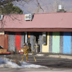 
              The door to Club Q is open as investigators continue to collect evidence after a mass shooting at the gay nightclub Wednesday, Nov. 23, 2022, in Colorado Springs, Colo.  The alleged shooter facing possible hate crime charges in the fatal shooting of five people at a Colorado Springs gay nightclub is scheduled to make their first court appearance Wednesday from jail after being released from the hospital a day earlier.  (AP Photo/David Zalubowski)
            