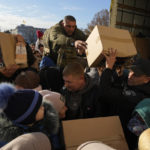 
              People receive humanitarian aid on central square in Kherson, Ukraine, Tuesday, Nov. 15, 2022. Waves of Russian airstrikes rocked Ukraine on Tuesday, with authorities immediately announcing emergency blackouts after attacks from east to west on energy and other facilities knocked out power and, in the capital, struck residential buildings. (AP Photo/Efrem Lukatsky)
            