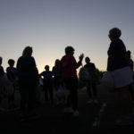 
              As the sun sets behind them, Kathi Schmeling, a coach and member of the Milwaukee Dancing Grannies, gives feedback to her teammates at a practice in Milwaukee on Wednesday, Nov. 2, 2022. The group has made a comeback after tragedy struck at a Christmas parade last November in Waukesha, Wisconsin. Three Grannies and one group member’s husband were struck and killed when a driver of an SUV sped through the parade route, killing a total of six people and injuring dozens of others. The Grannies, who’ve vowed not to let the tragedy stop them, plan to perform at this year’s Christmas parade in Waukesha. (AP Photo/Martha Irvine)
            