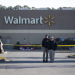 
              Police wait outside a Walmart in Chesapeake, Va. on Wednesday, Nov. 23, 2022 where the night before a mass shooting took place. (Billy Schuerman/The Virginian-Pilot via AP)
            