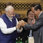 
              FILE - India's Prime Minister Narendra Modi, left, holds the gavel with Indonesia's President Joko Widodo during handover ceremony at the G20 Leaders' Summit, in Nusa Dua, Bali, Indonesia Nov. 16, 2022. India officially takes up its role as chair of the Group of 20 leading economies for the coming year Thursday, Dec. 1 and it's putting climate at the top of the group's priorities. (Willy Kurniawan/Pool Photo via AP, File)
            