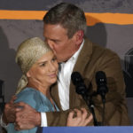 
              Tennessee Gov. Bill Lee kisses his wife, Maria, as he speaks to supporters after he was declared the winner in his bid for re-election, Tuesday, Nov. 8, 2022, in Franklin, Tenn. (AP Photo/Mark Humphrey)
            