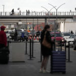 
              Travellers wait and cars gather at Hartsfield-Jackson Atlanta International Airport in Atlanta, Tuesday, Nov. 22, 2022. (AP Photo/Brynn Anderson)
            