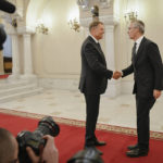 
              NATO Secretary-General Jens Stoltenberg, right, shakes hands with Romanian President Klaus Iohannis in Bucharest, Romania, Monday, Nov. 28, 2022, a day before the start of the meeting of NATO Foreign Ministers. NATO returns to the scene of one of its most controversial decisions and where it intends to repeat its vow that Ukraine, now suffering through the tenth month of a war against Russia, will be able to join the world's biggest military alliance one day. (AP Photo/Alexandru Dobre)
            