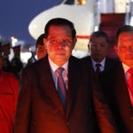 
              Cambodia's Prime Minister Hun Sen, center, arrives at Ngurah Rai International Airport ahead of the G20 Summit in Bali, Indonesia Nov. 14, 2022. Hun Sen tested positive for COVID-19 at G-20, Monday, Nov. 14, days after hosting world leaders at summit in Phnom Penh. (Ajeng Dinar Ulfiana/Pool Photo via AP)
            