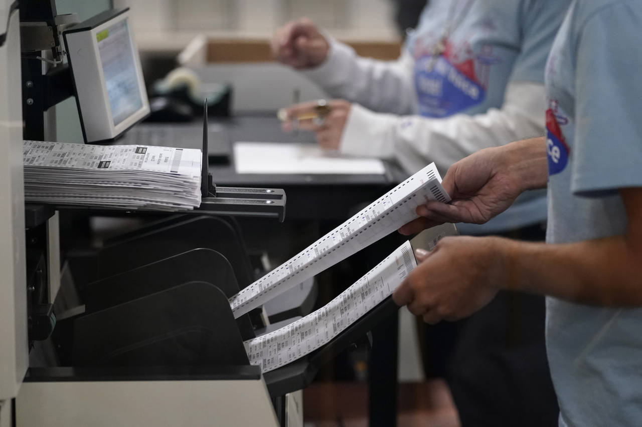 Election workers process ballots at the Clark County Election Department, Friday, Nov. 11, 2022, in...
