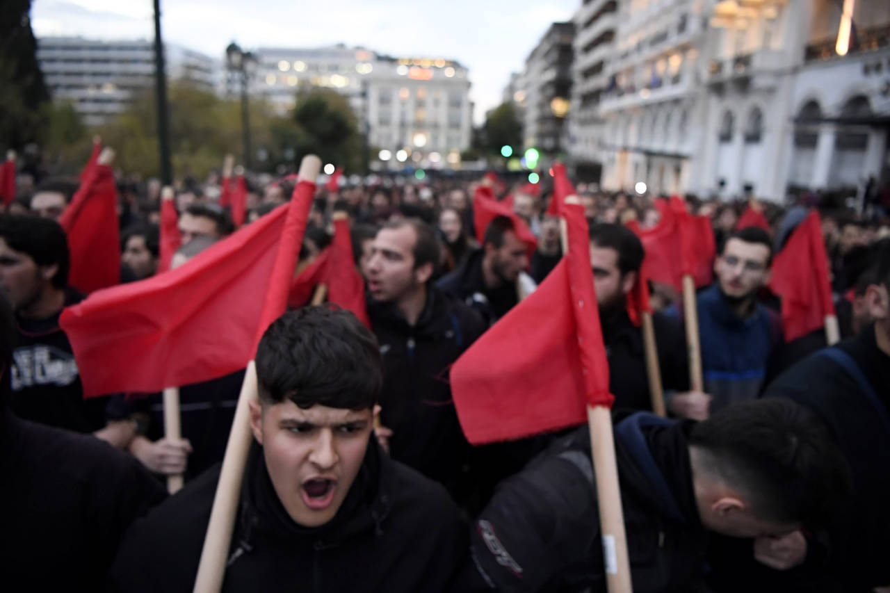Protestors march as they shoot slogans during a rally, in Athens, Greece, Thursday, Nov. 17, 2022. ...