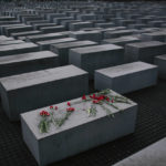 
              File- Flowers lie on a concrete slab of the Holocaust Memorial to mark the International Holocaust Remembrance Day and commemorating the 70th anniversary of the liberation of the Nazi Auschwitz death camp in Berlin, Jan. 27, 2015. Holocaust survivors from around the world are warning about the reemergence of antisemitism as they commemorated Wednesday, Nov. 9, 2022, the 84th anniversary of the Kristallnacht or the "Night of Broken Glass", when Nazis terrorized Jews throughout Germany and Austria. (AP Photo/Markus Schreiber, File)
            