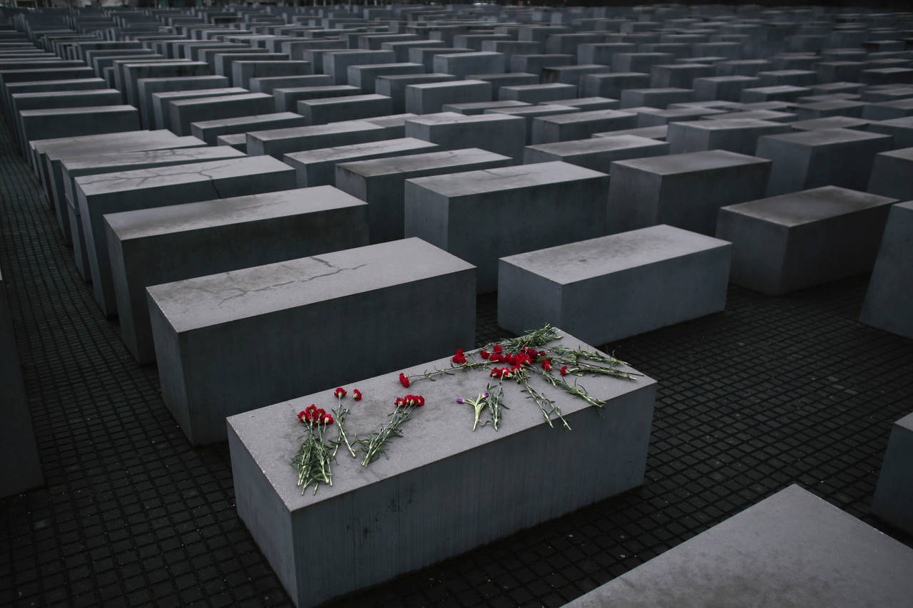 File- Flowers lie on a concrete slab of the Holocaust Memorial to mark the International Holocaust ...