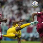 
              Ecuador's Felix Torres, center, duels for the ball with Qatar's Abdulaziz Hatem, right, during the World Cup, group A soccer match between Qatar and Ecuador at the Al Bayt Stadium in Al Khor, Sunday, Nov. 20, 2022. (AP Photo/Ariel Schalit)
            