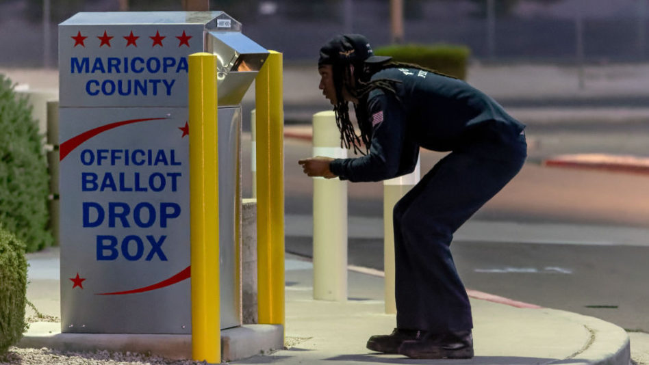 A voter casts his ballot at a drop box on Nov. 8, 2022, in Mesa, Arizona. After months of candidate...