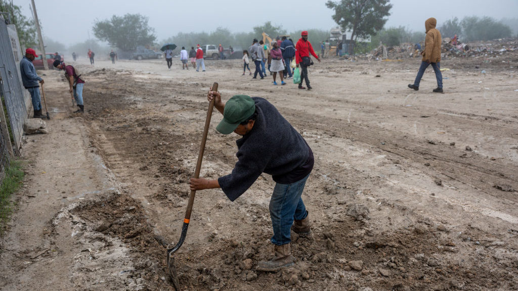 A city worker cleans outside a migrant shelter on December 3, 2022 in Reynosa, Mexico. Thousands of...