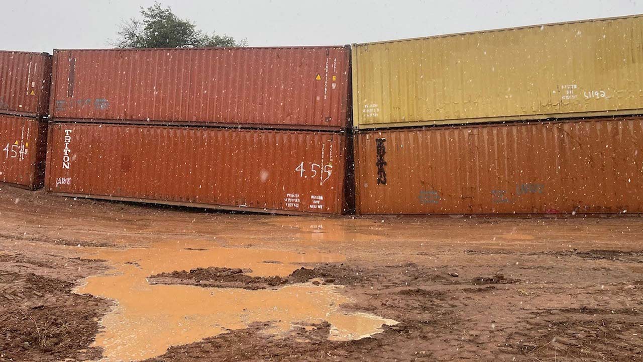 Shipping containers can be seen blocking water along the U.S.-Mexico border in southern Arizona. (P...