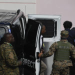 
              FTX founder Sam Bankman-Fried, top right, is escorted from a corrections van into the Magistrate Court in Nassau, Bahamas, Monday, Dec. 19, 2022. (AP Photo/Rebecca Blackwell)
            