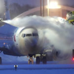 
              An American Airlines plane is de-iced as high winds whip around 7.5 inches of new snow at Minneapolis-St. Paul International Airport Thursday, Dec. 22, 2022. Temperatures plunged far and fast Thursday as a winter storm formed ahead of Christmas weekend, promising heavy snow, ice, flooding and powerful winds across a broad swath of the country and complicating holiday travel. (David Joles/Star Tribune via AP)
            