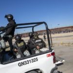 
              Mexican National Guard patrols the southern bank of the Rio Grande as hundreds of migrants wait in line to enter into El Paso, Texas from Ciudad Juarez, Mexico, Wednesday, Dec. 21, 2022. Thousands of migrants gathered along the Mexican side of the southern border Wednesday, camping outside or packing into shelters as they waited for the U.S. Supreme Court to decide whether and when to lift pandemic-era restrictions that have prevented many from seeking asylum. (AP Photo/Andres Leighton)
            