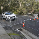 
              Barricades block the street near the family home of FTX founder Sam Bankman-Fried in Palo Alto, Calif., Friday, Dec. 23, 2022. Bankman-Fried's parents agreed to sign a $250 million bond and keep him at their California home while he awaits trial on charges that he swindled investors and looted customer deposits on his FTX trading platform. (AP Photo/Jeff Chiu)
            