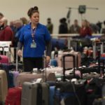 
              A Southwest Airlines employee helps a traveler search for bags amongst hundreds of other checked bags at baggage claim at Midway International Airport as Southwest continues to cancel thousands of flights across the country Wednesday, Dec. 28, 2022, in Chicago. (AP Photo/Erin Hooley)
            